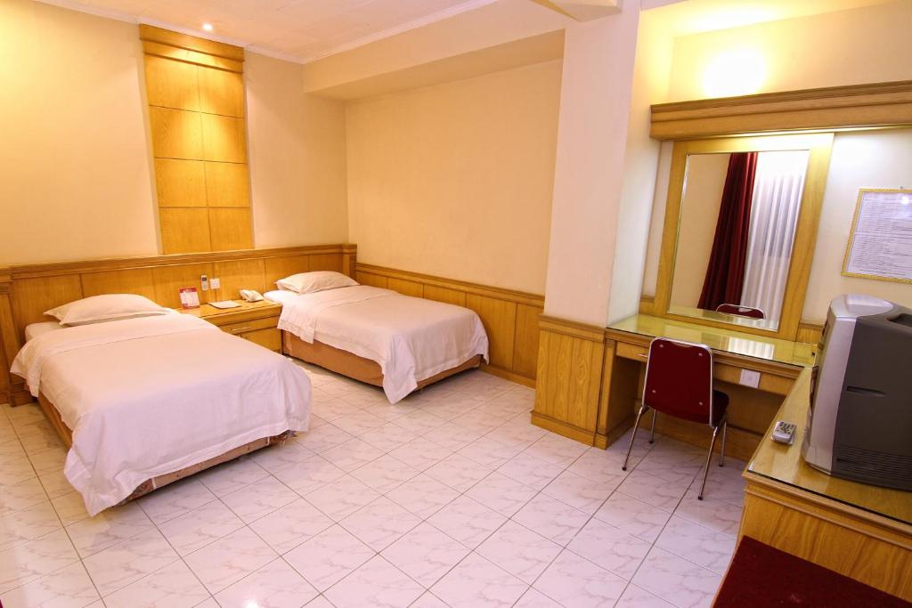 Postel nebo postele na pokoji v ubytování Hotel Hangtuah