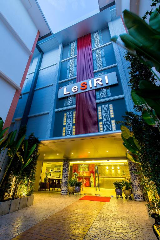 a store front of a building with a sign on it at Rung Aroon Hotel By Le Siri in Chiang Mai