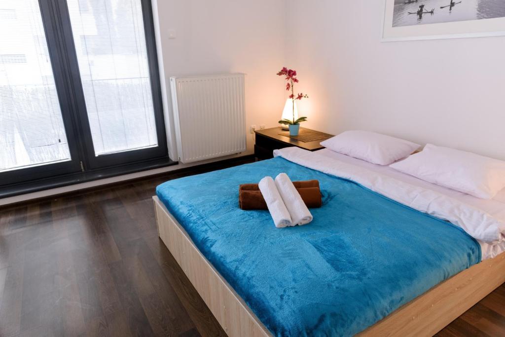 ワルシャワにあるDekart Arkadia Apartmentsのベッドルーム1室(大型ベッド1台、タオル2枚付)