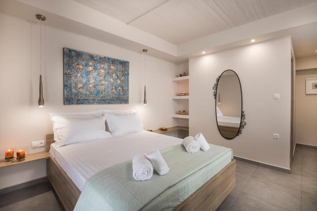 a bedroom with a large bed with towels on it at Camara Residence in Chania Town