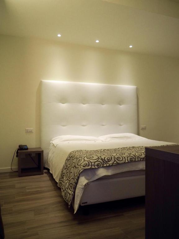 Postel nebo postele na pokoji v ubytování Hotel Riposo