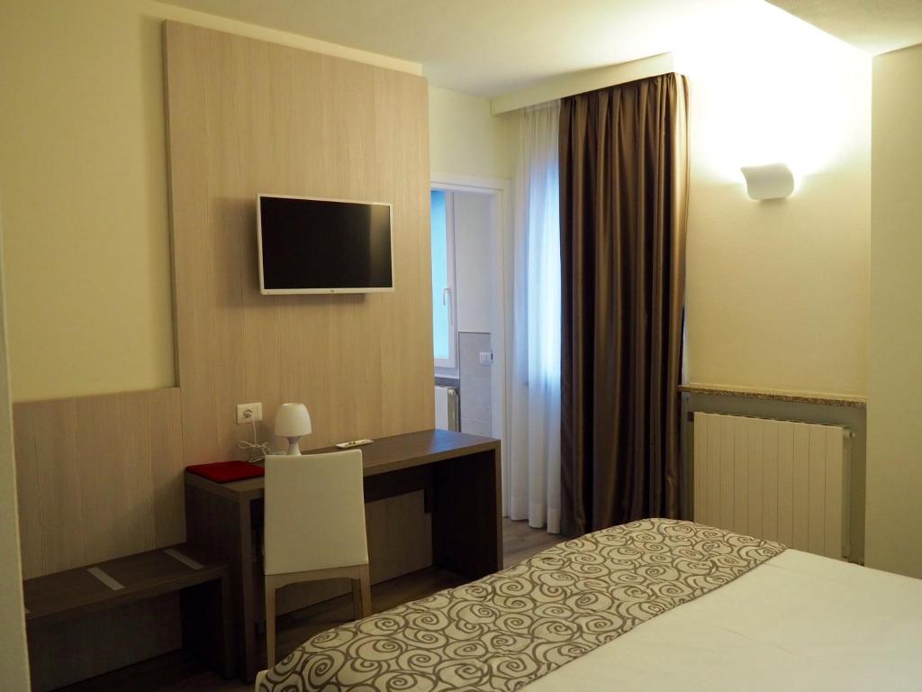 Postel nebo postele na pokoji v ubytování Hotel Riposo
