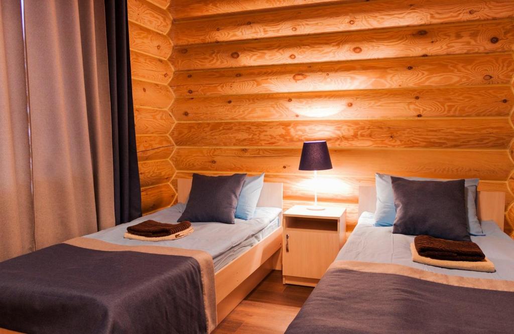 a bedroom with two beds and two lamps at Ladoga Fjord in Koirinoya
