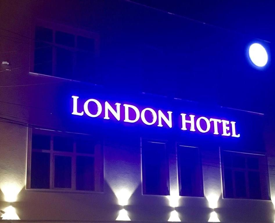 a neon sign for a london hotel on a building at London Hotel in Constanţa