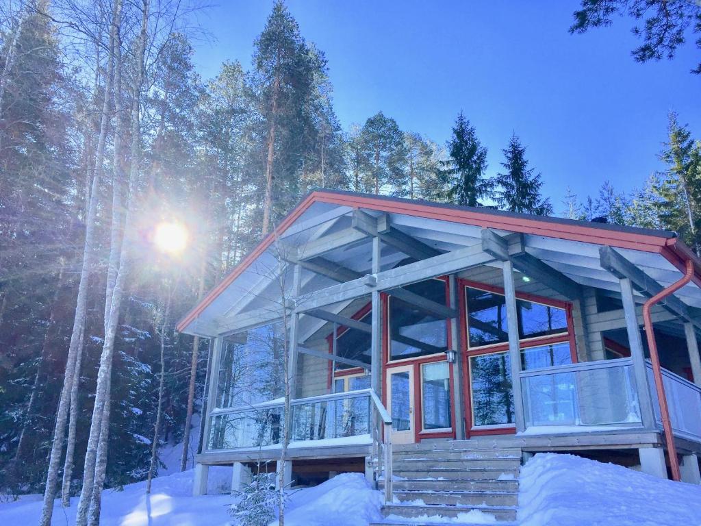 a cabin in the woods in the snow at Villa by the Lake in Joutseno