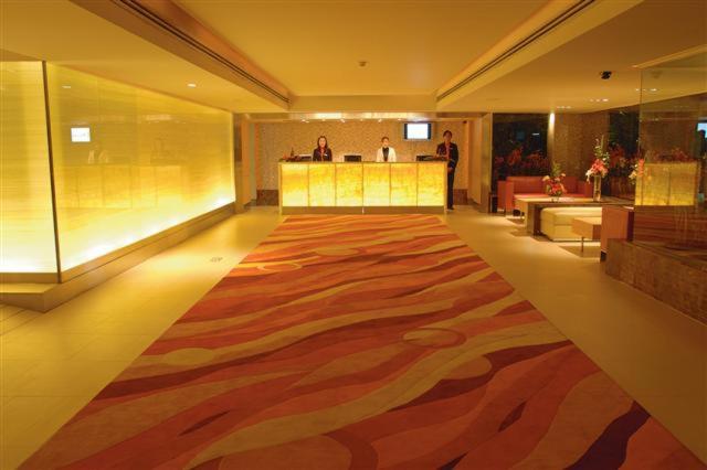 a lobby with a large rug on the floor at The Tivoli Hotel in Bangkok