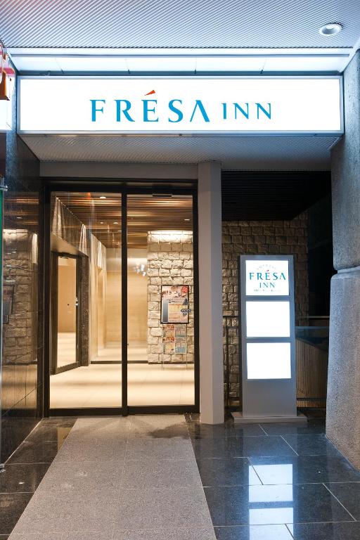 a store with a sign on the front of a building at Sotetsu Fresa Inn Tokyo-Toyocho in Tokyo
