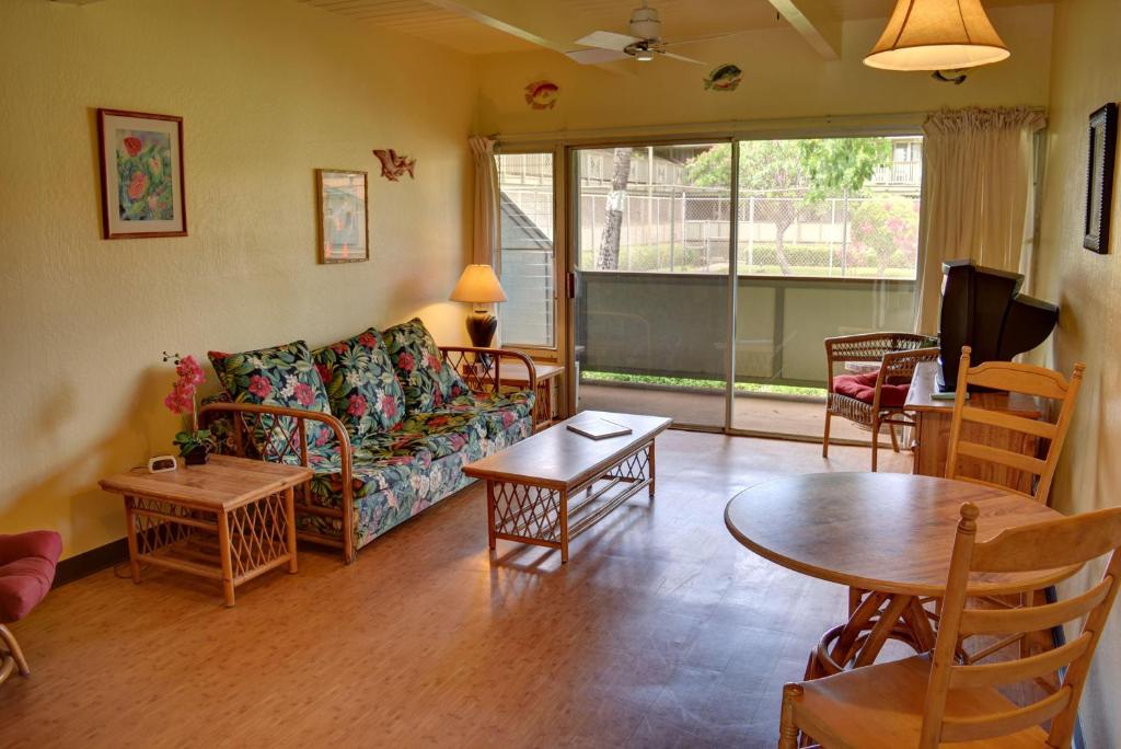 a living room with a couch and a table at Kihei Bay Surf 117 in Kihei
