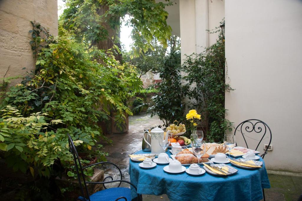 a table with a blue table cloth with food on it at Palazzo Bernardini Suites in Lecce