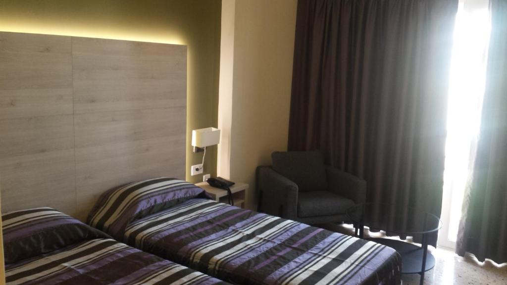 Postel nebo postele na pokoji v ubytování Il Palazzin Hotel