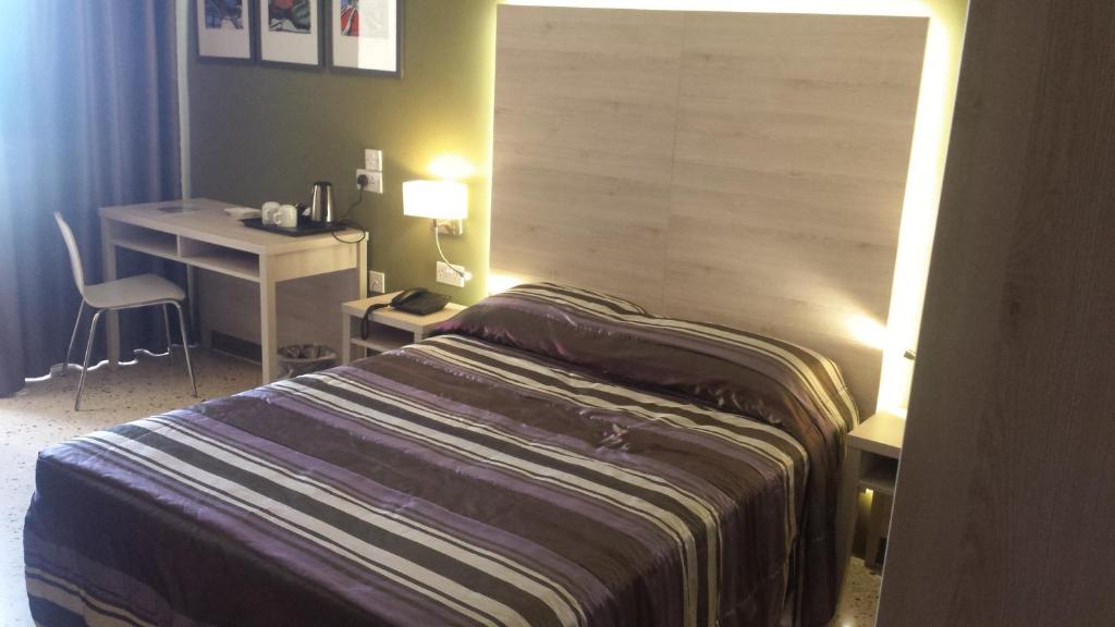 Postel nebo postele na pokoji v ubytování Il Palazzin Hotel