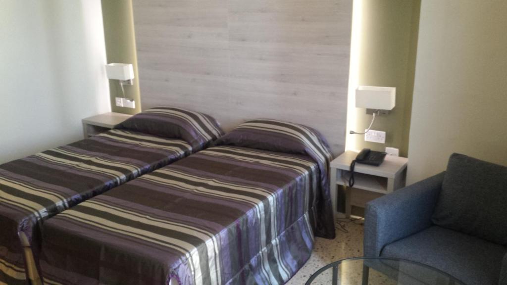 Postel nebo postele na pokoji v ubytování Il Palazzin Hotel