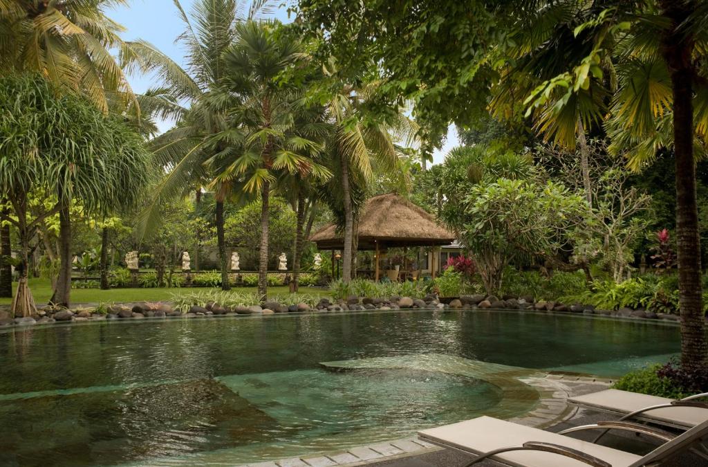 
a beach with palm trees and palm trees at Segara Village Hotel in Sanur
