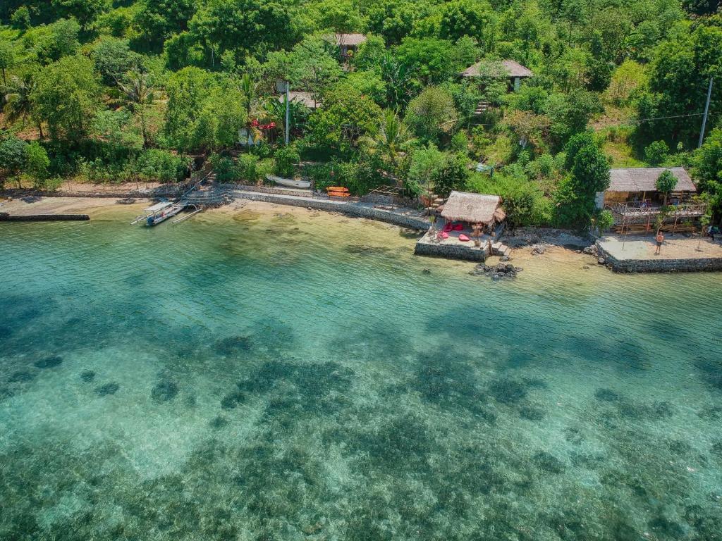 an aerial view of a beach in the water at Tanjungan in Gili Gede