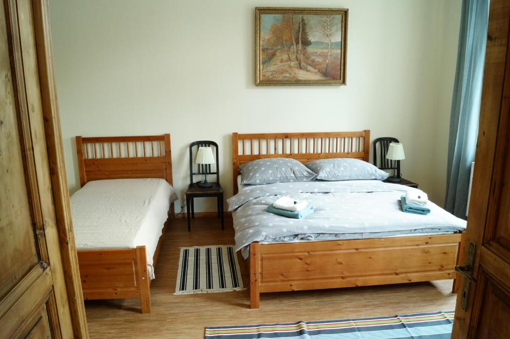 a bedroom with two beds and a picture on the wall at Apartmány Mary in Litoměřice