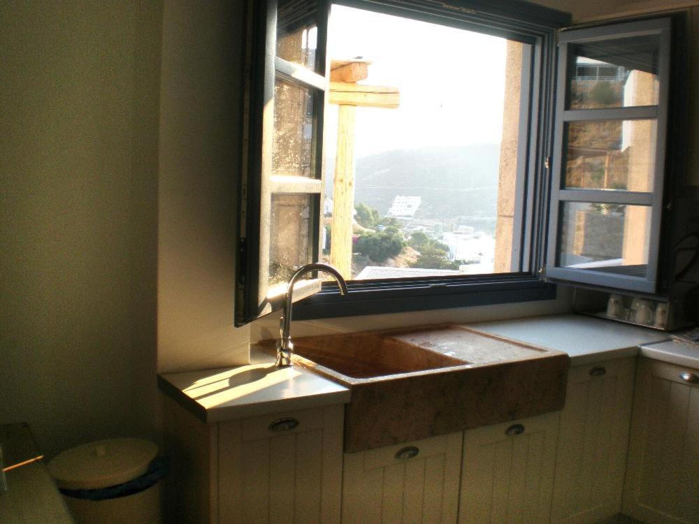 a kitchen with a sink and a window at Luxury house in the island of Patmos in Grikos