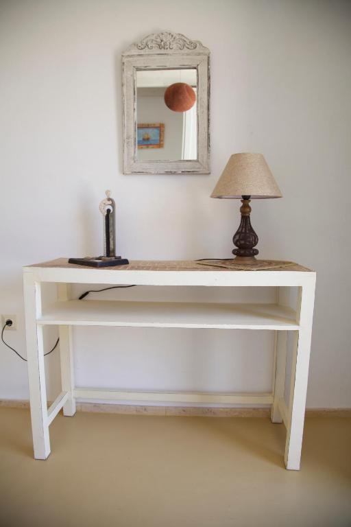 a white desk with a lamp and a mirror at Luxury house in the island of Patmos in Grikos