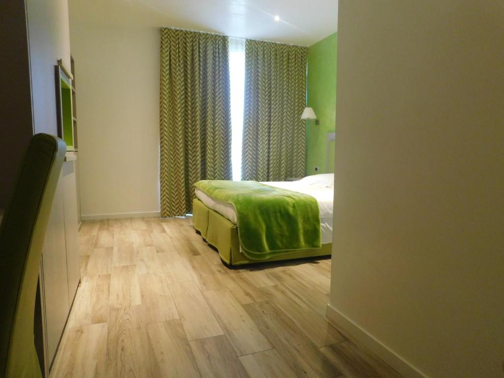 Llit o llits en una habitació de Palace Hotel & SPA La CONCHIGLIA D' ORO