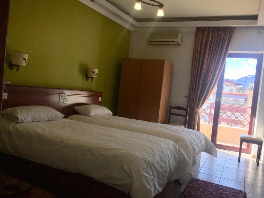 Postel nebo postele na pokoji v ubytování Hotel Olympion
