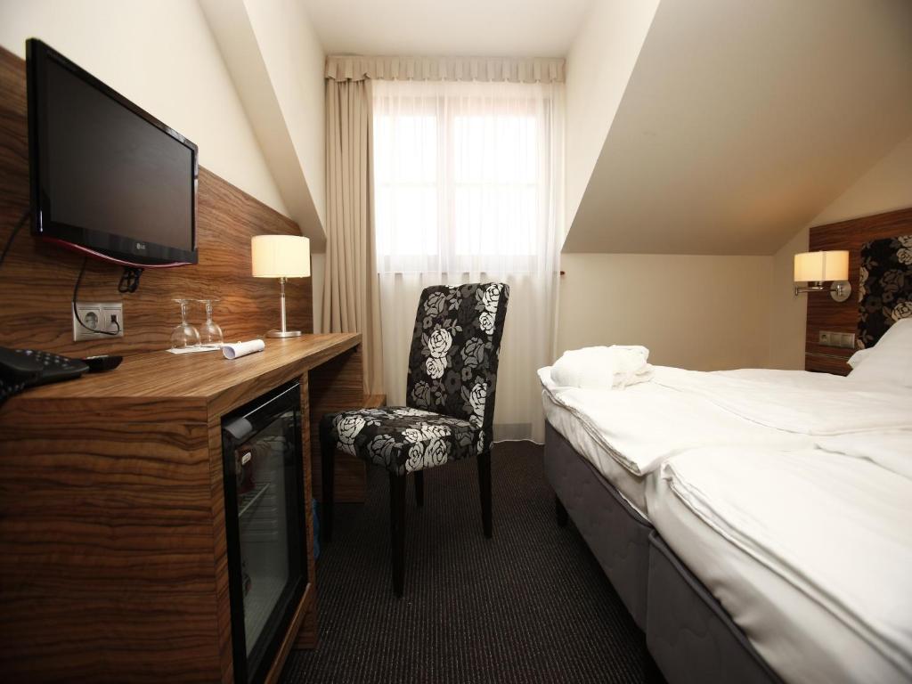 Postel nebo postele na pokoji v ubytování Bodrogi Kúria Wellness Hotel