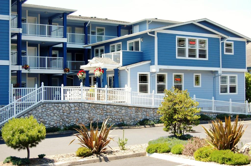 a blue apartment building with white railings at The Landing at Newport Condominium Hotel in Newport