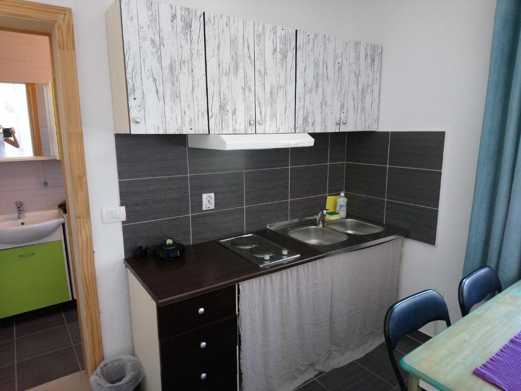 a small kitchen with a sink and a counter at Apartments Lozina in Živogošće
