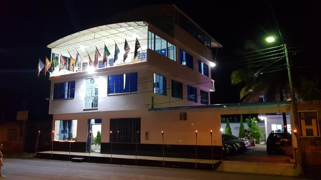 a building with flags on top of it at night at Tropical Resort Tocaima in Tocaima