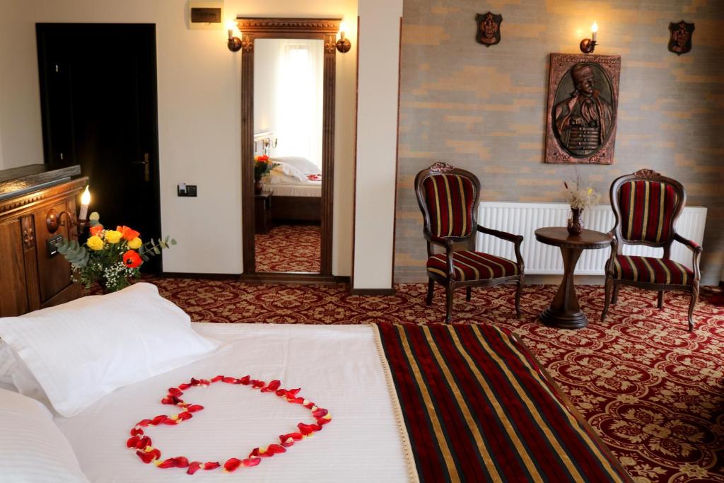 a bedroom with a bed with a heart on it at Castel Transilvania in Baia Mare