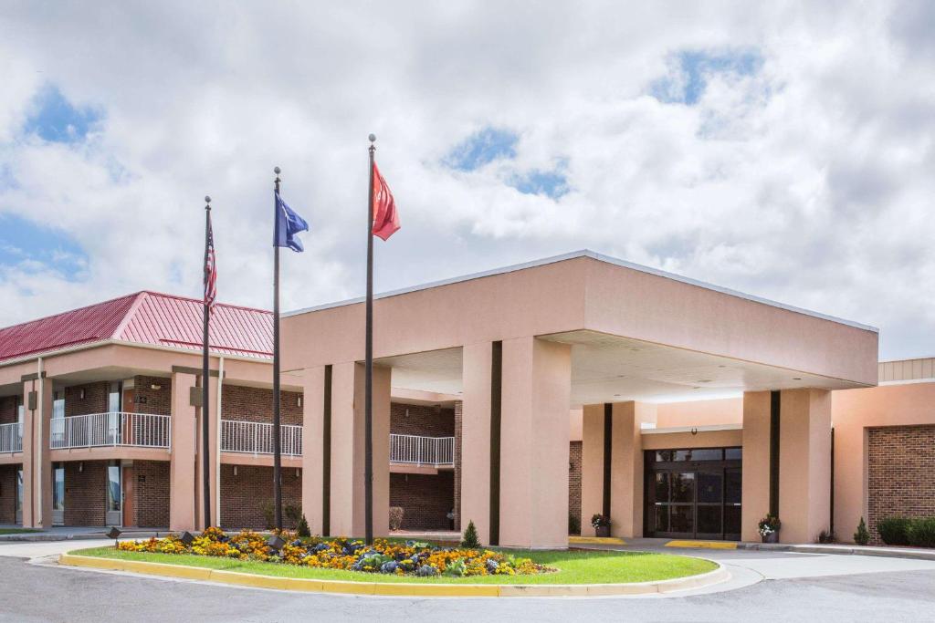 a building with two flags in front of it at Ramada by Wyndham Wytheville in Wytheville