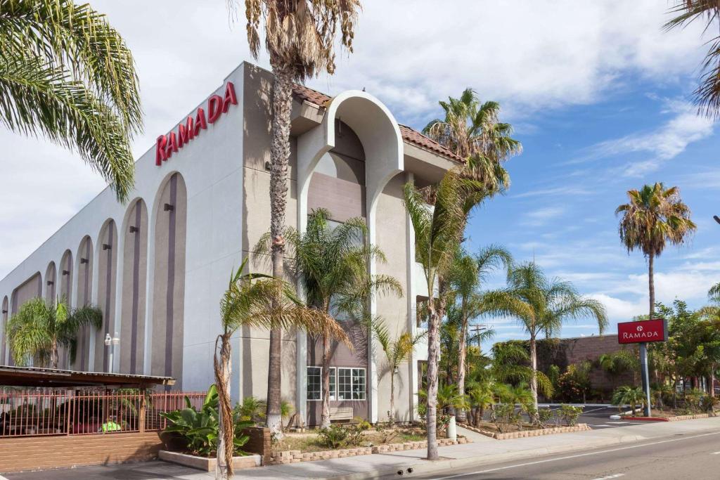 a mobil oil building on a street with palm trees at Ramada by Wyndham Oceanside in Oceanside