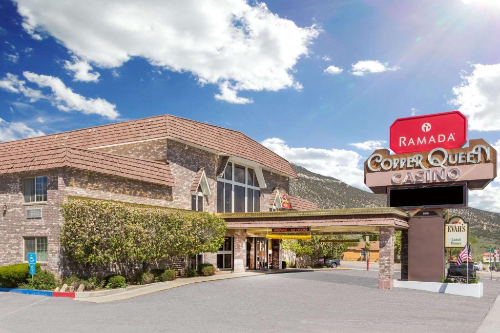 a building with a sign in front of it at Ramada by Wyndham Ely in Ely