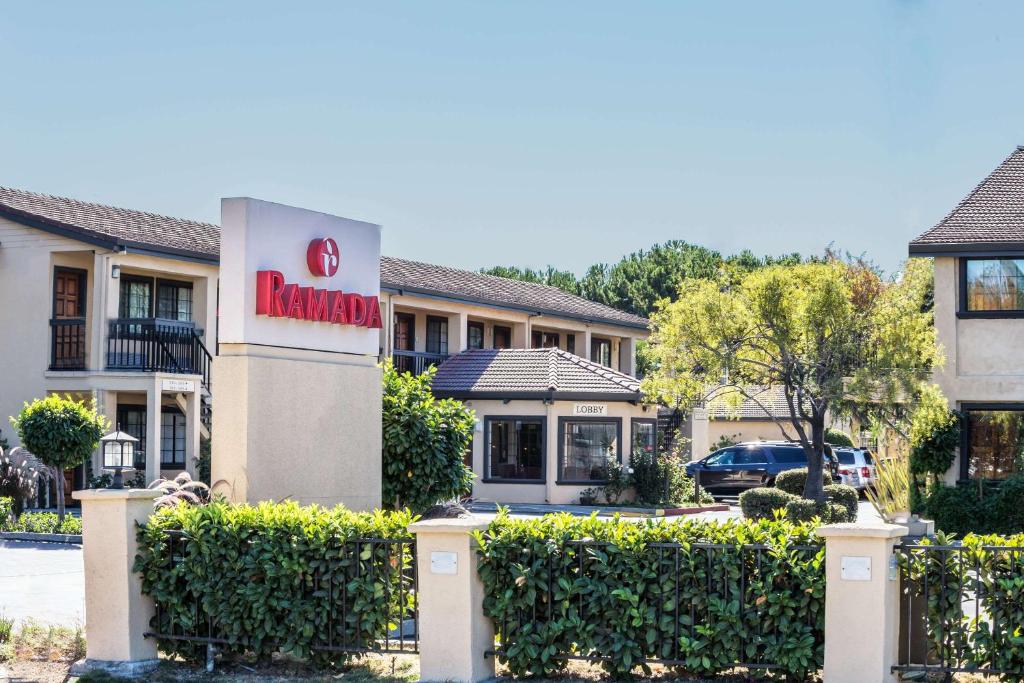 a hotel with a sign on the front of a building at Ramada by Wyndham Mountain View in Mountain View