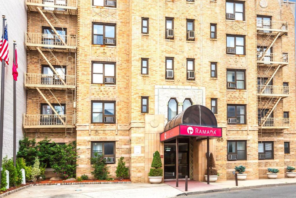 un edificio de ladrillo con un cartel de farmacia delante en Ramada by Wyndham Jersey City, en Jersey City