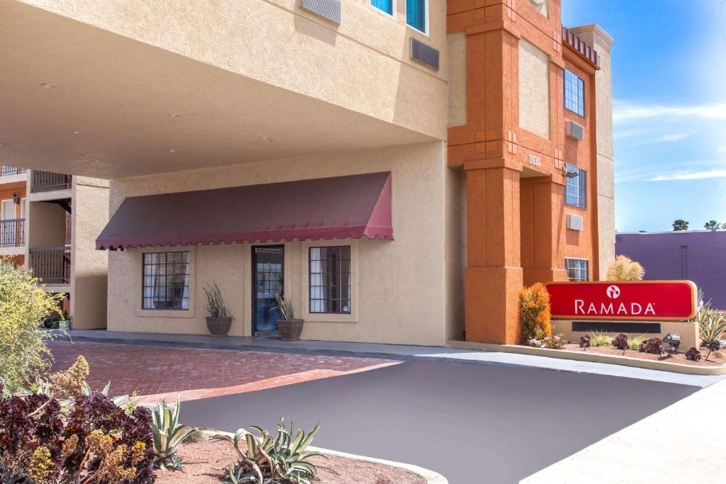 a hotel with a sign in front of a building at Ramada by Wyndham Culver City in Los Angeles