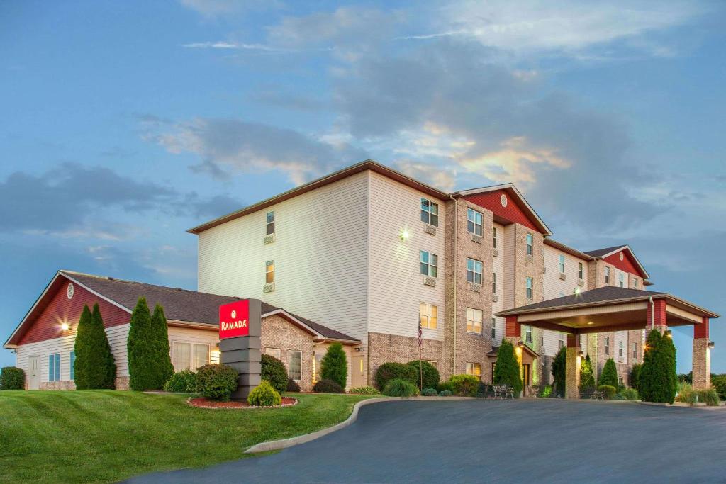 a hotel with a sign in front of a building at Ramada by Wyndham Sparta/At Speedway in Sparta