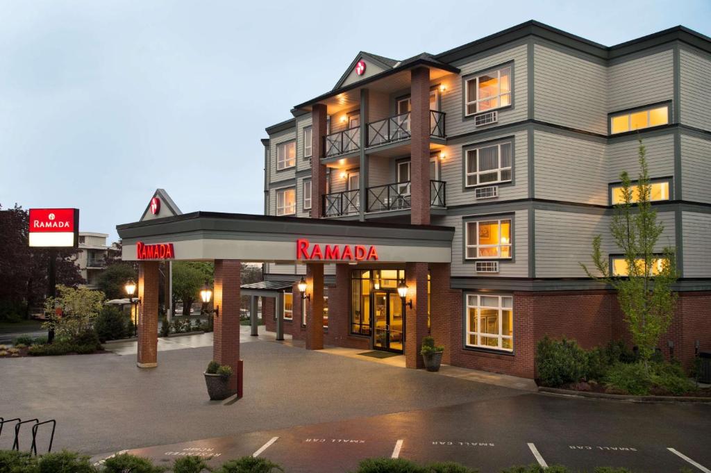 a large building with a karma sign in front of it at Ramada by Wyndham Nanaimo in Nanaimo