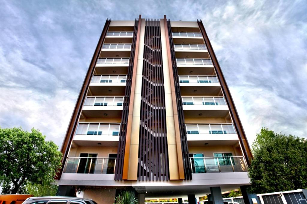 a tall apartment building with at The Aim Sathorn Hotel in Bangkok