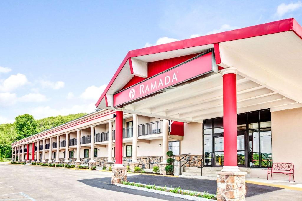 a hotel building with a sign that reads ramnadal at Ramada by Wyndham Rockaway in Rockaway