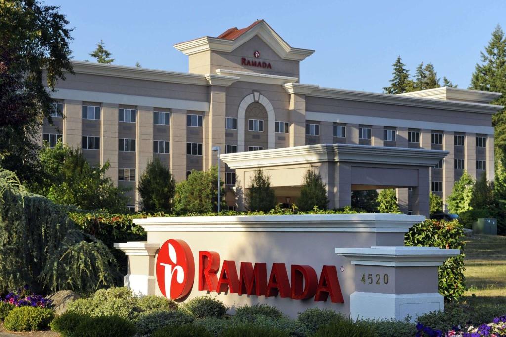 a building with a sign in front of it at Ramada by Wyndham Olympia in Olympia