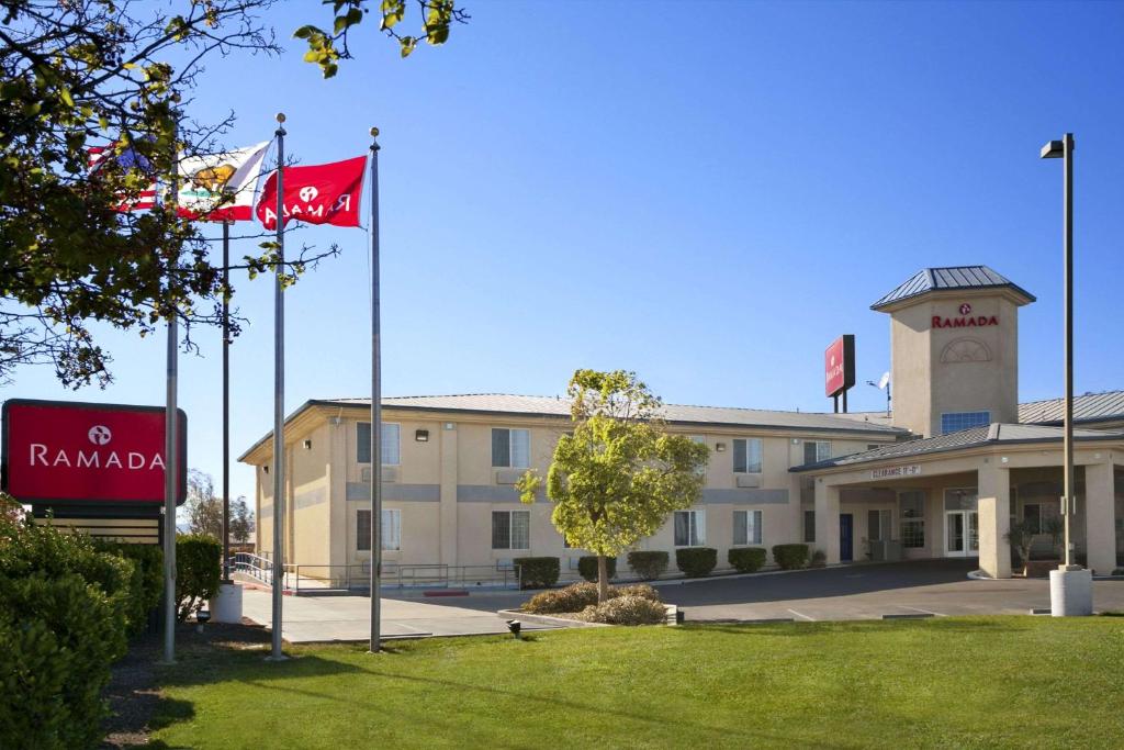 a building with two flags in front of it at Ramada by Wyndham Williams in Williams