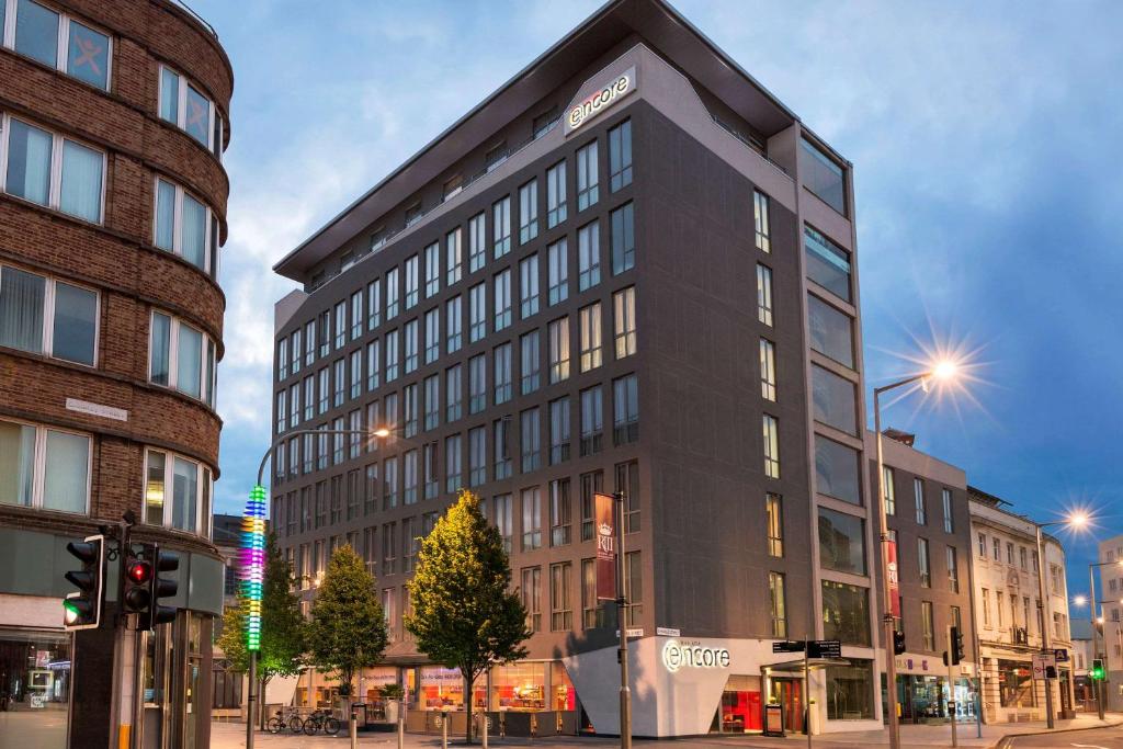 a tall black building on a city street at Ramada Encore Leicester City Centre in Leicester