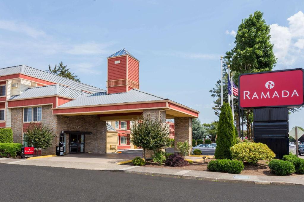 a hotel with a sign in front of a building at Ramada by Wyndham Portland in Portland