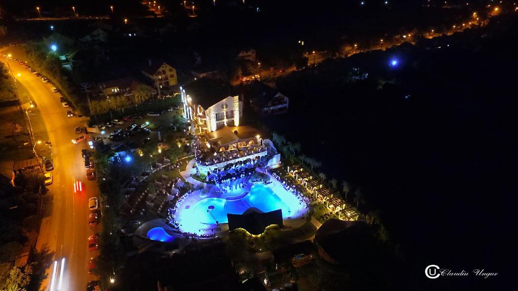 an overhead view of a pool at night with lights at Castel Transilvania in Baia Mare