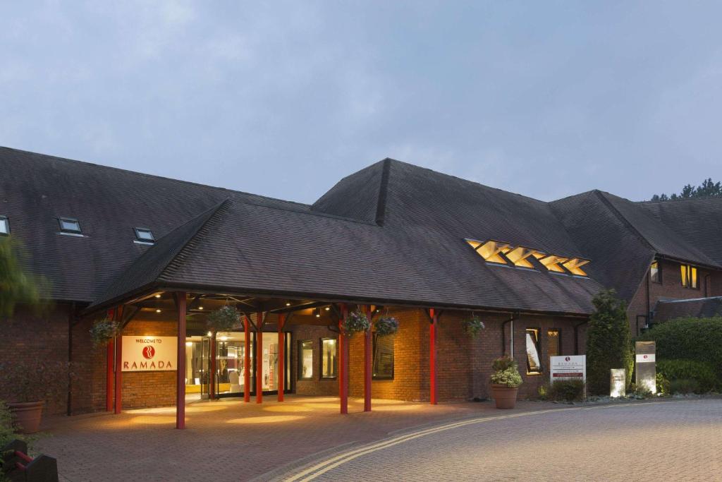 a building with a black roof on a street at Ramada Telford Ironbridge in Telford