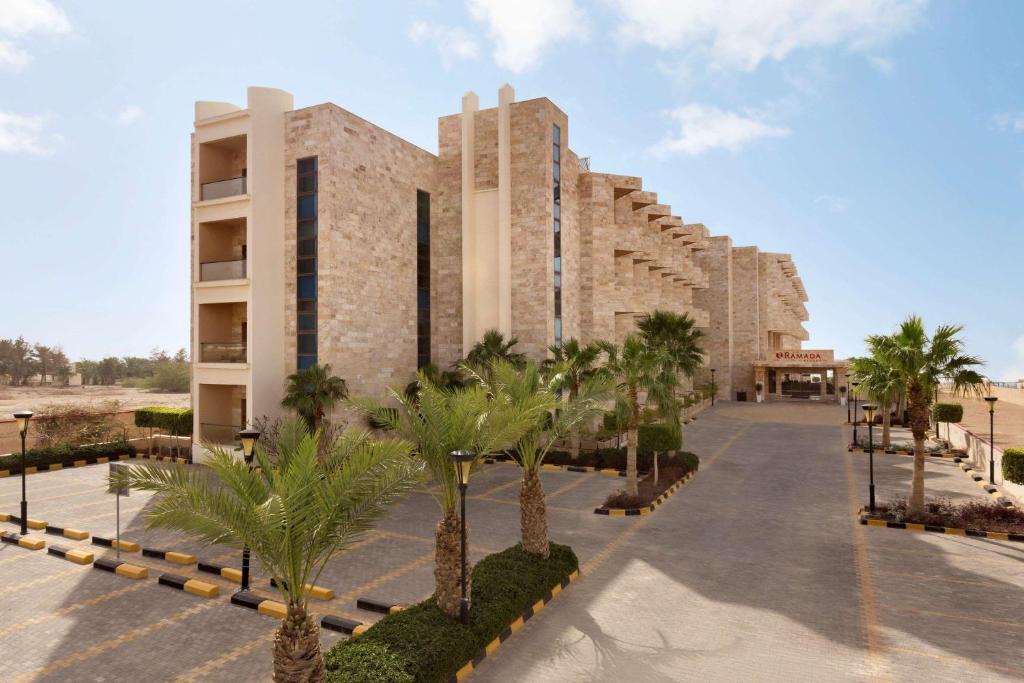
a large building with a lot of windows at Ramada Resort Dead Sea in Sowayma
