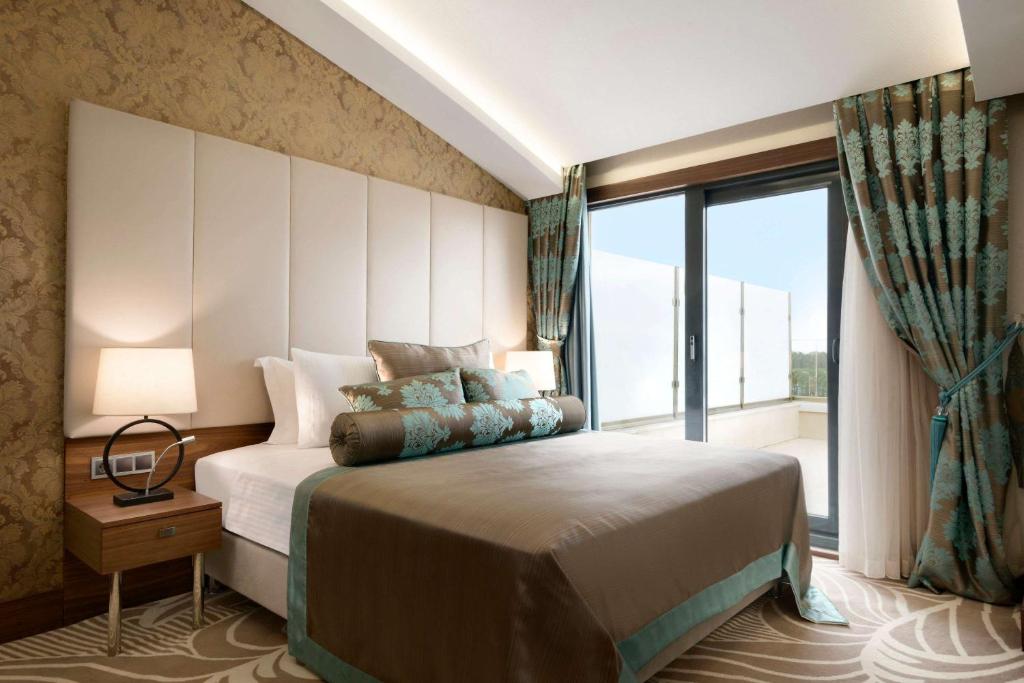 A bed or beds in a room at Ramada by Wyndham Yalova