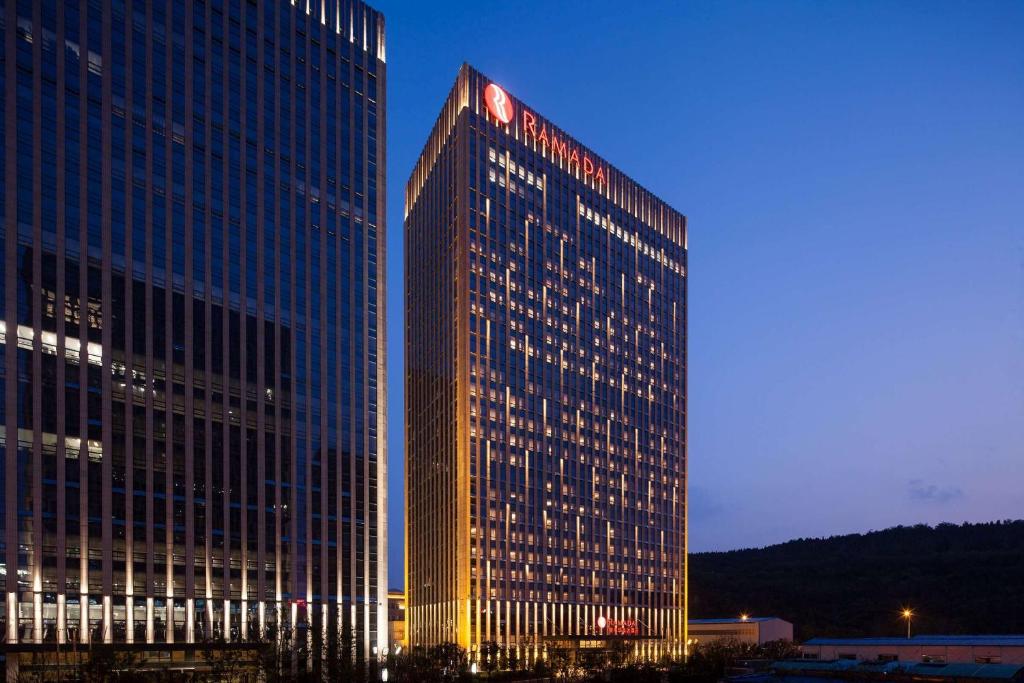 a tall building with a clock on top of it at Ramada Jinan in Jinan