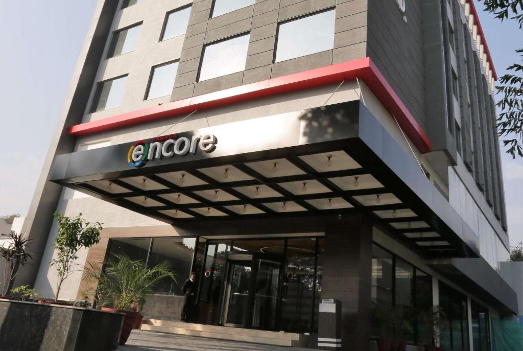a building with a sign on the front of it at Ramada Encore Jalandhar in Jalandhar