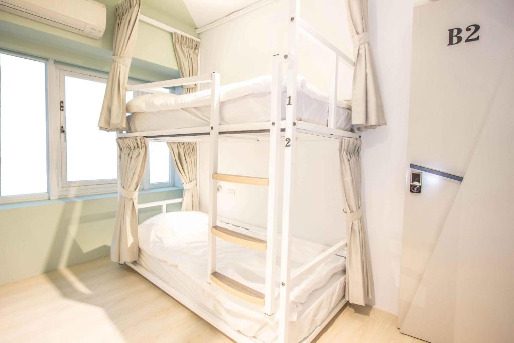 Postel nebo postele na pokoji v ubytování Light Inn