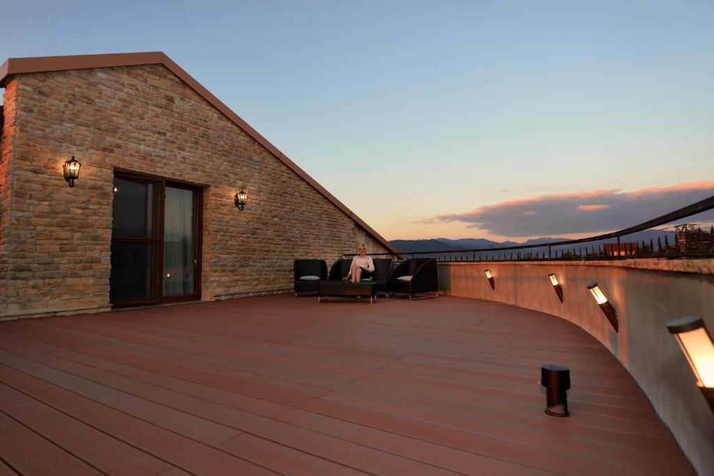 a large deck with furniture on a building at Castel Transilvania in Baia Mare